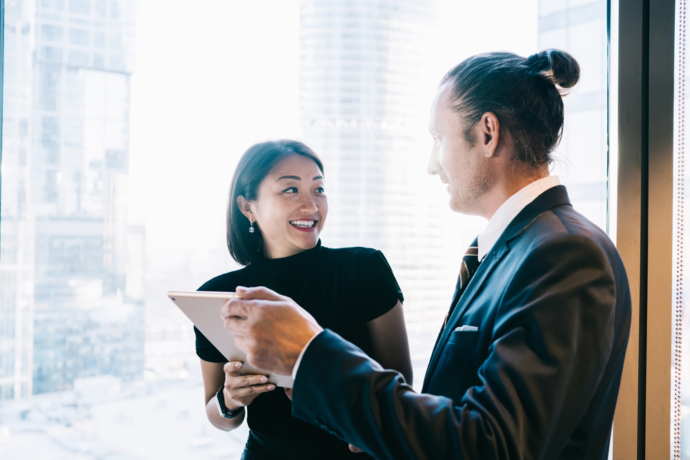 Two employees discussing something on a tablet